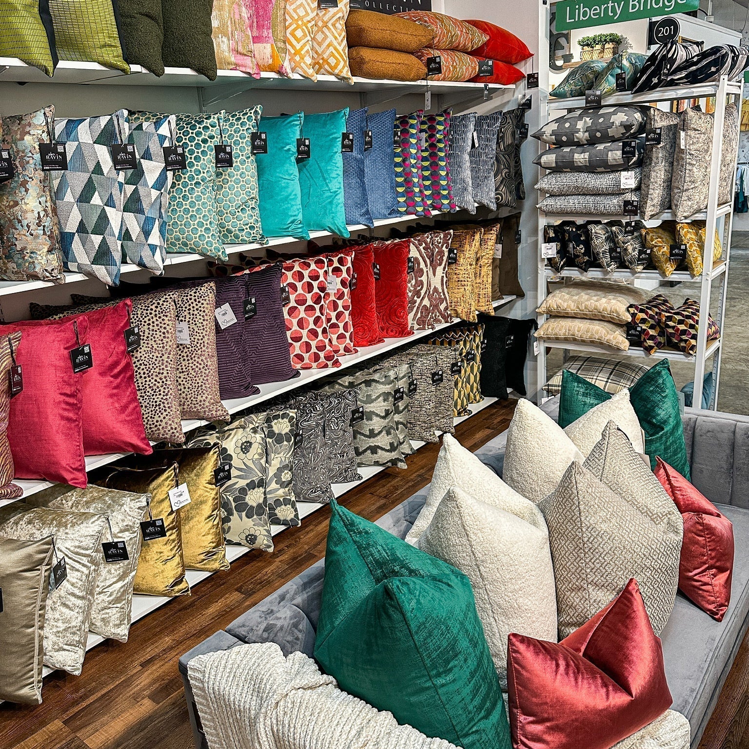 Colorful display of pillows in a storefront setting
