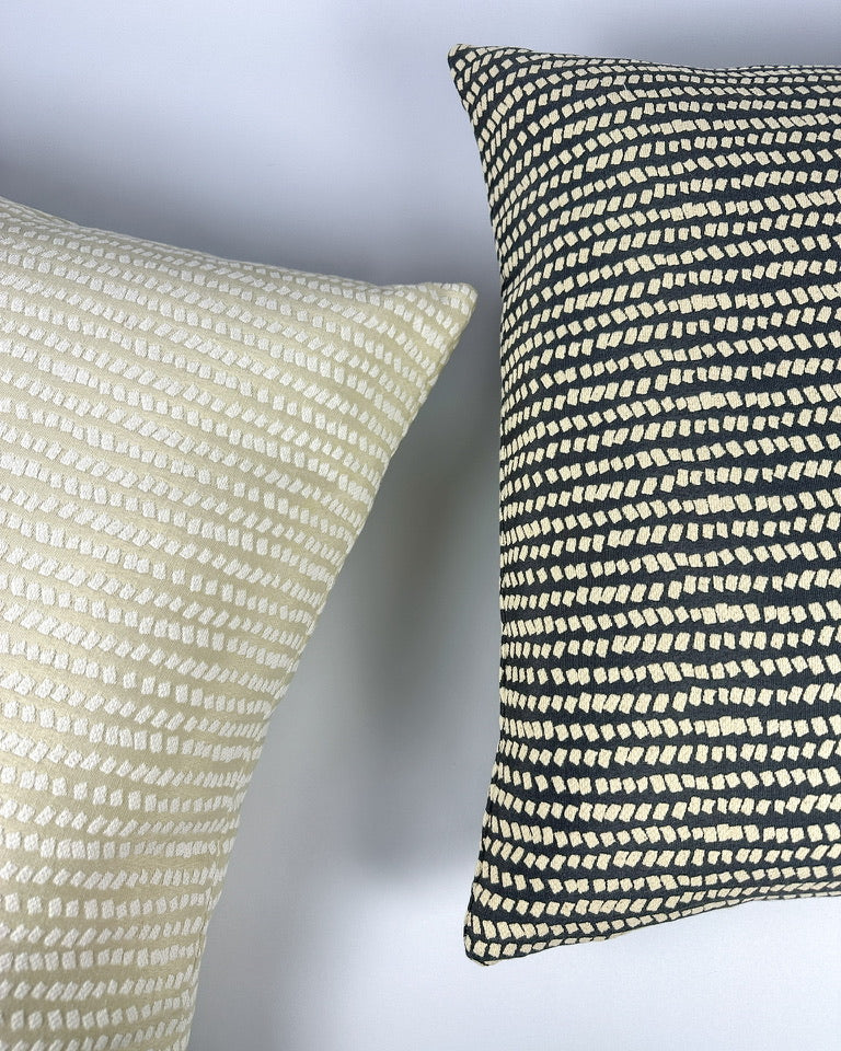 Woven pillow covers with dotted geometric pattern.