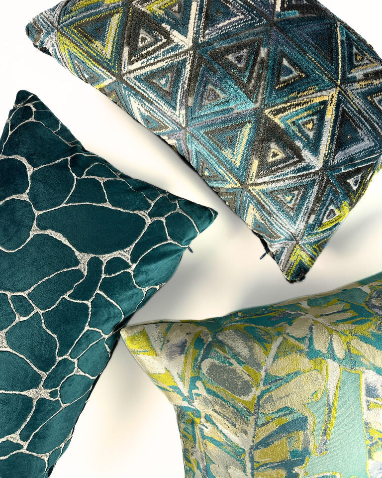 Geometric patterned accent pillows in teal shade