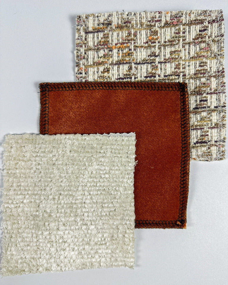 Textured fabric swatches in ivory and rust colors