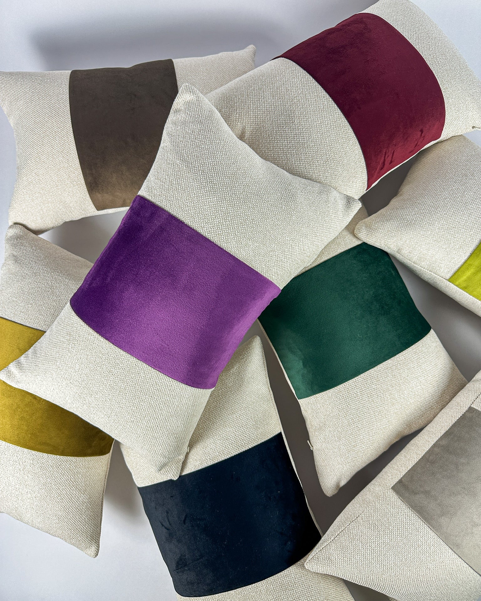 Paneled velvet and woven lumbars with varying colors