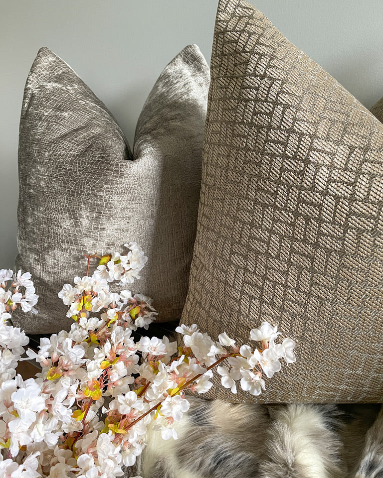 Neutral throw pillows with faux fur throw blanket and floral stem