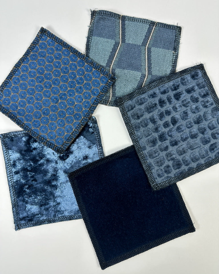 Fabric swatches all navy toned with various patterns and styles