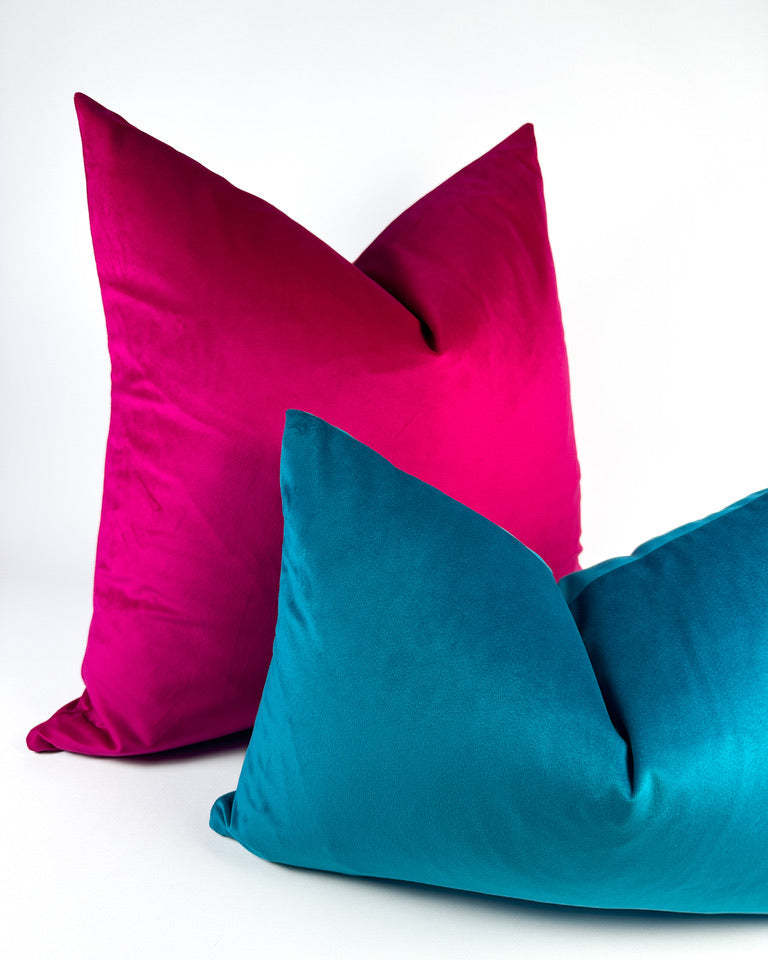 Bright pink and teal colored velvet accent pillows
