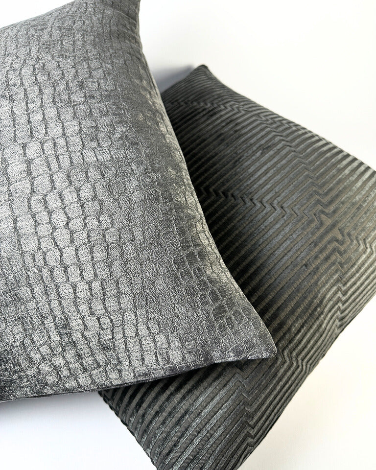 Grey snake print pillow cover on white backdrop