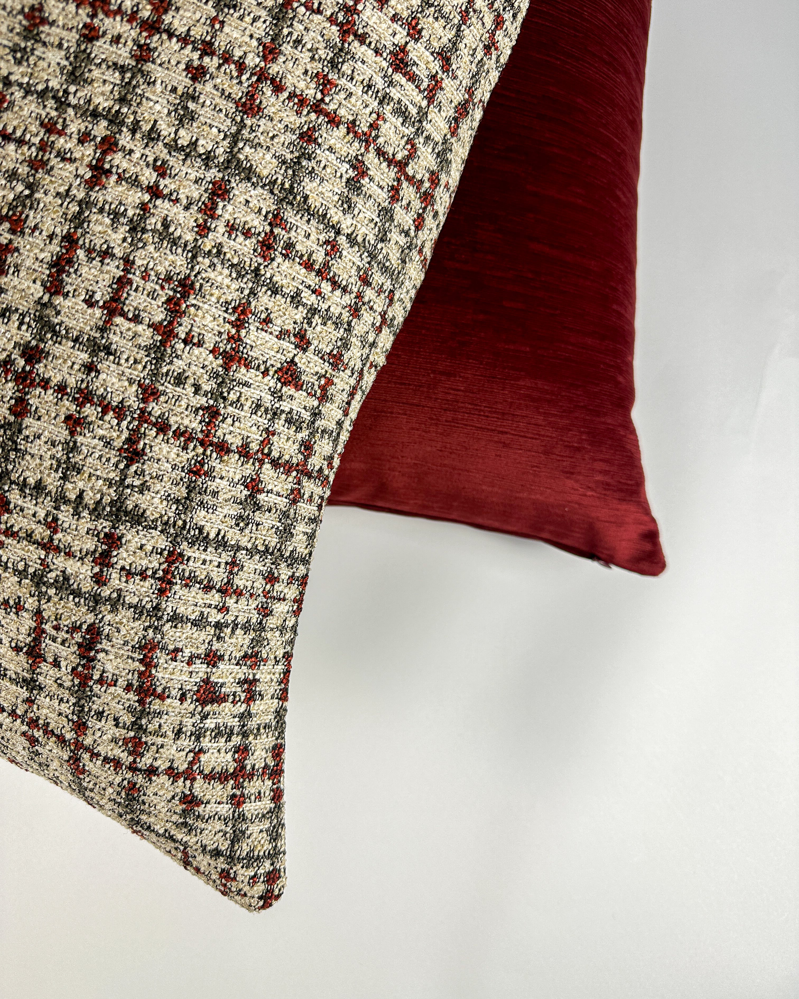 Burgundy plaid print cover with solid velvet cover in the background
