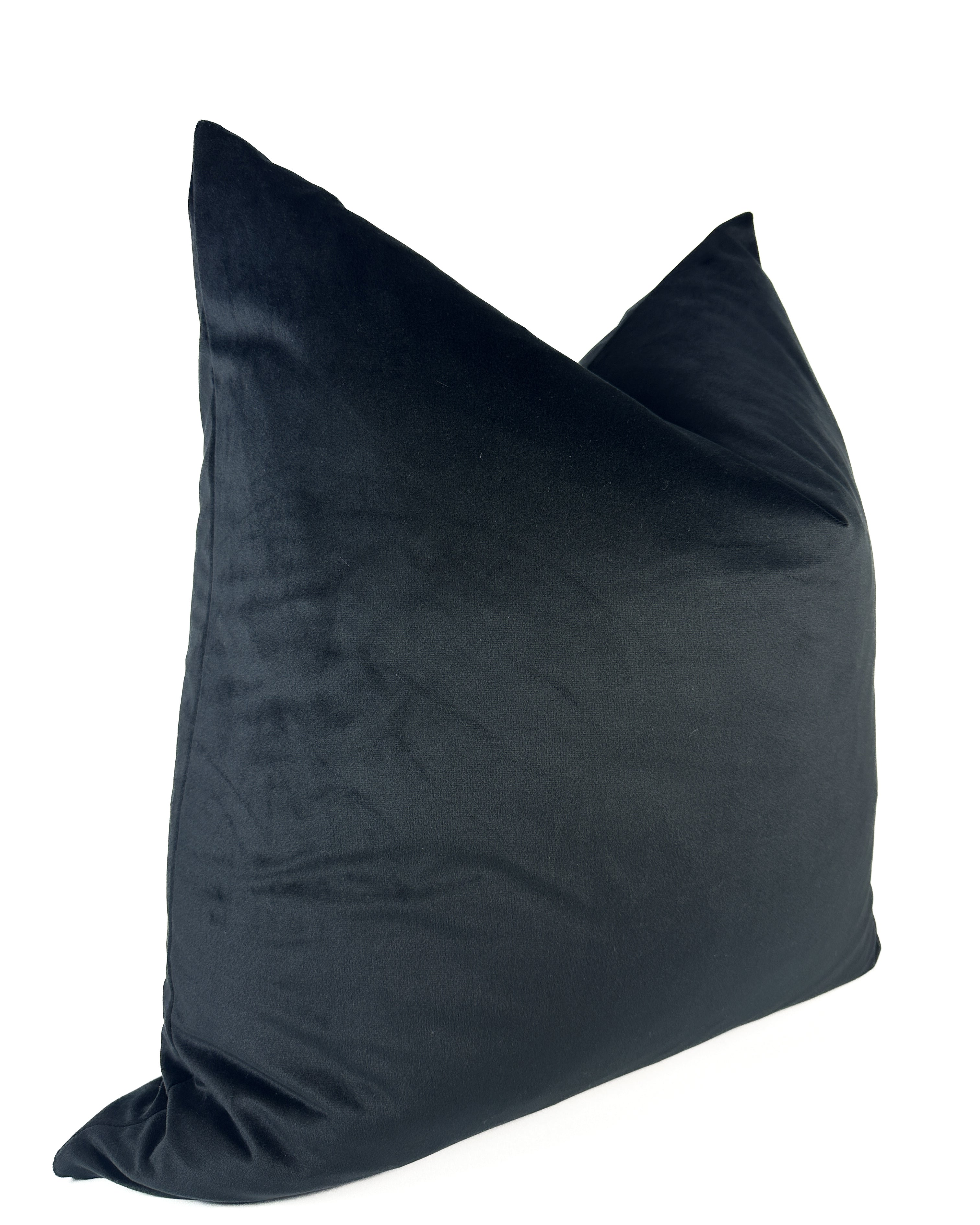 A black velvet pillow cover with a zipper closure, displaying a smooth and solid texture.