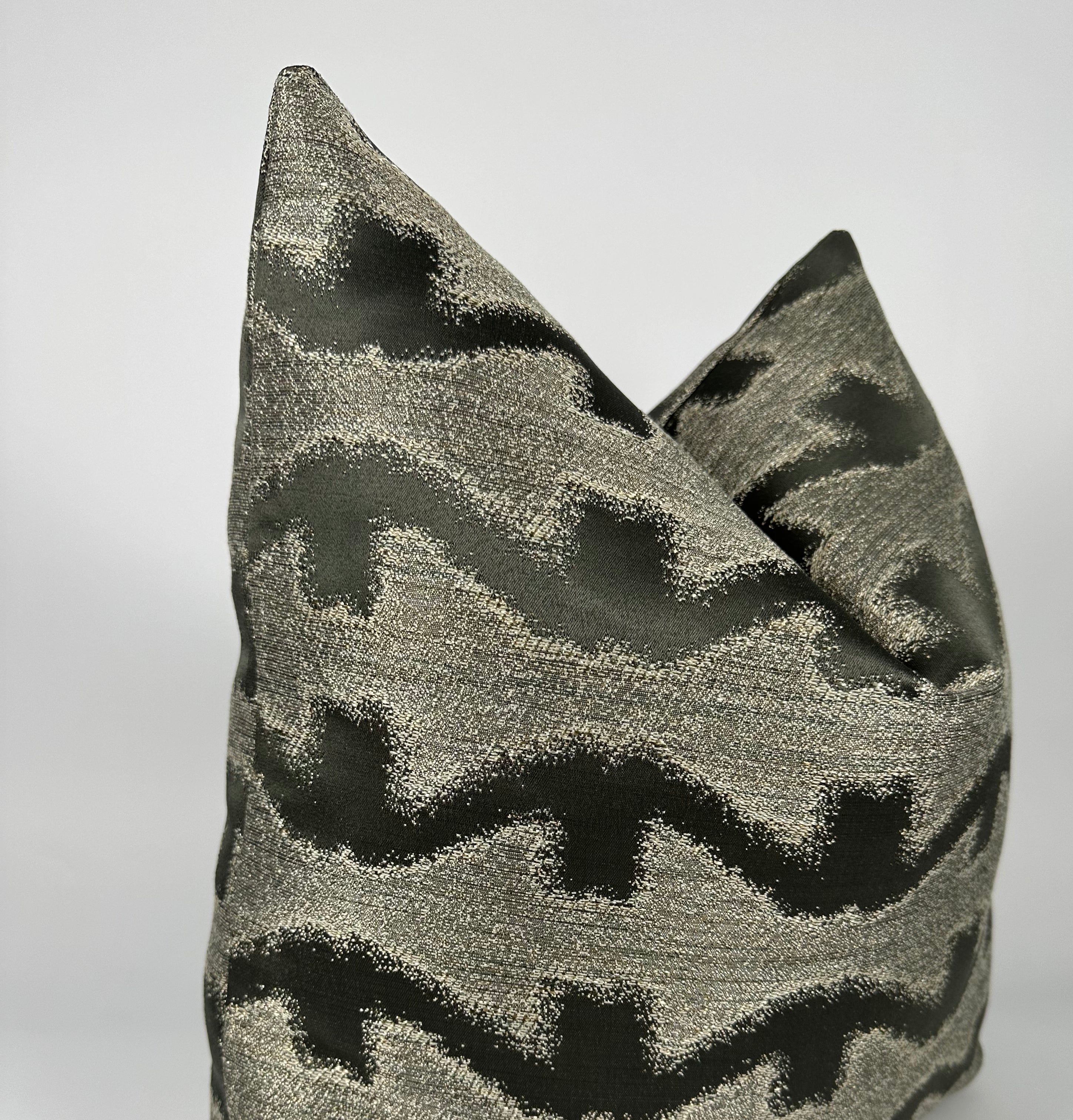 A gray and black patterned pillow cover.