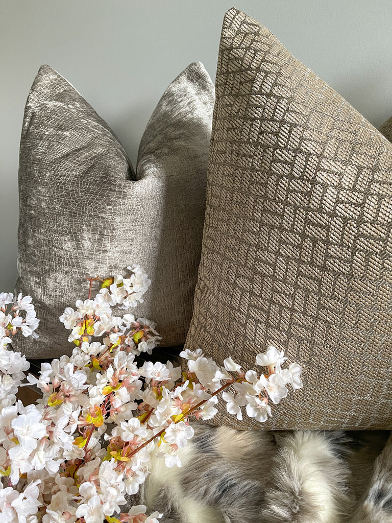 Neutral throw pillows with faux fur throw blanket and floral stem