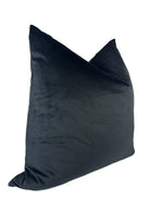 A black velvet pillow cover with a zipper closure, displaying a smooth and solid texture.