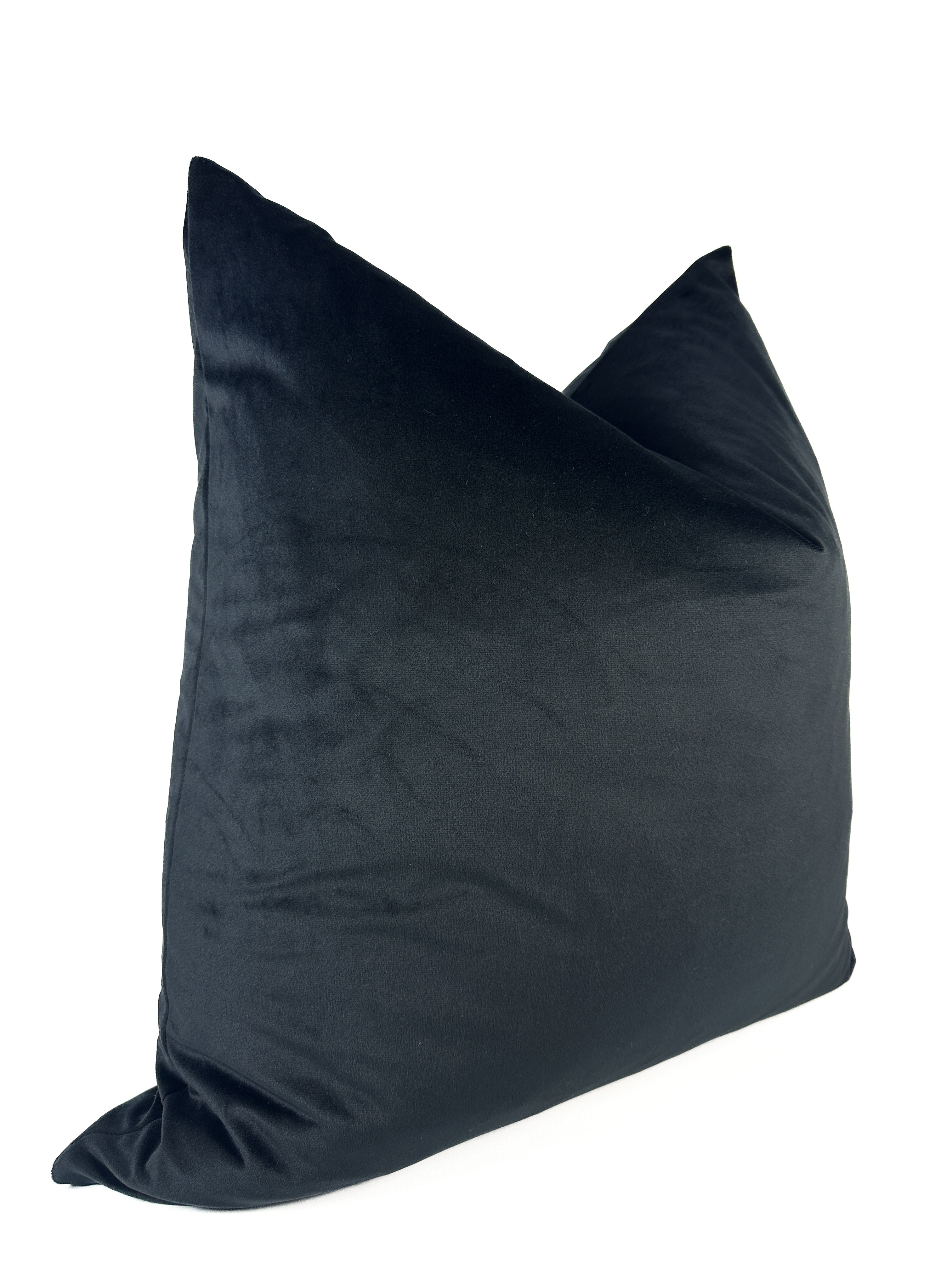 A black velvet pillow cover with a zipper closure, displaying a smooth and solid texture.