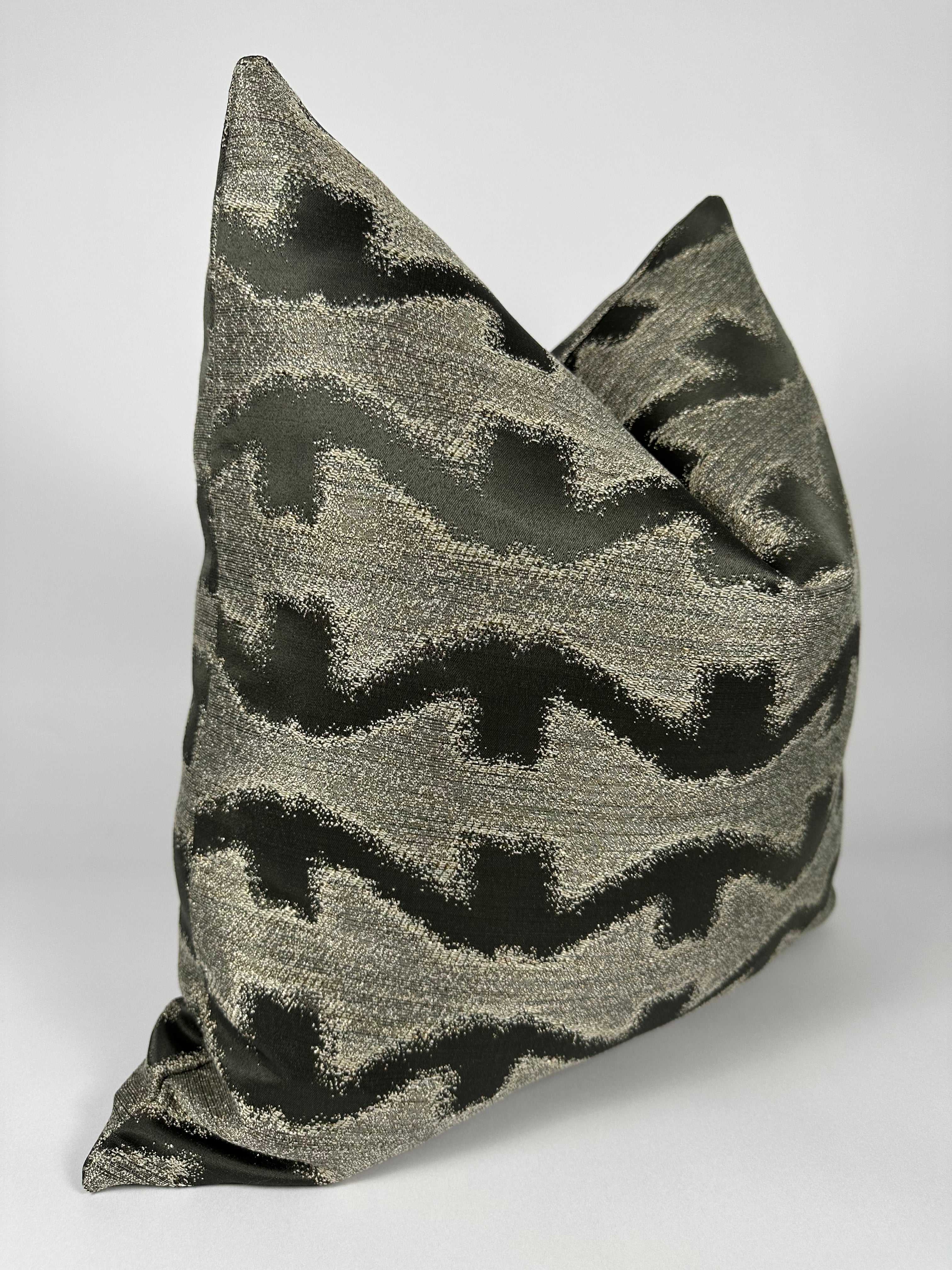 A gray and black patterned pillow cover.