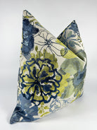 A triangular-shaped pillow cover with a floral pattern in blue and green shades.