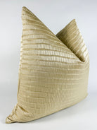 A champagne gold pillow cover with a textured design, that reveals the shimmering silver undertone.